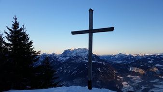 large cross on top of the Kaiser mountains