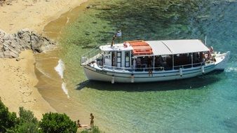 touristic boat on the diamanti beach, greece