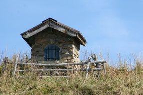 a chapel with a fence on top of a mountain