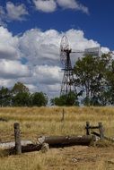 distant view of an ancient windmill amid a rural landscape