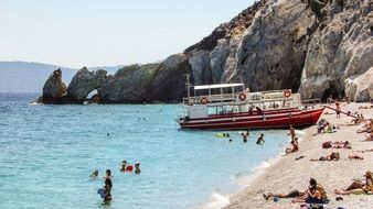 tourists on the lalaria beach, greece, skiathos