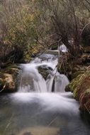 waterfall among the autumn landscape