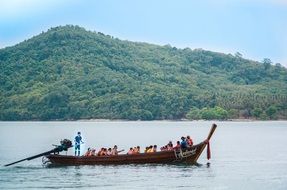 boat with tourists off the coast of thailand on a sunny day