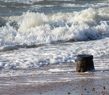 Waves in the water on the sandy coastline