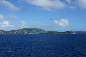 view from the water on the rocky coast of the british virgin islands