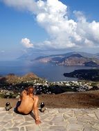 man sits on top of a mountain in italy