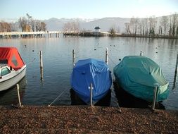 covered boats on a lake in zurich