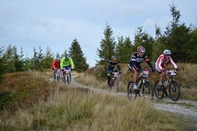 group of mountain bikers on a dirt road
