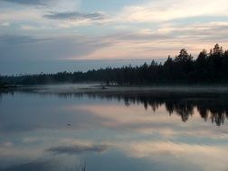 fog over forest lake in Finland