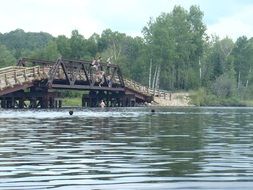 people jump from the bridge into the lake