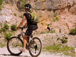 photo of tired cyclists in mountains