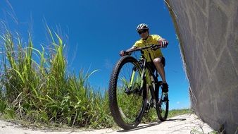 young man riding bike on trail