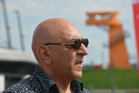 bald man in sun glasses at a festival in hamburg