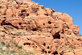 erosion on a sandy cliff under the bright sun