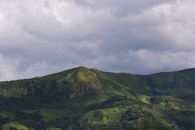 thunderclouds over green mountains