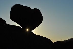 dark rock silhouette in bright sunlight