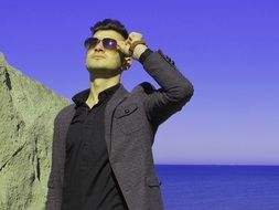 man in glasses against the sea