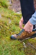 feet in a sneaker on green grass