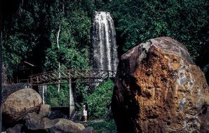 metal bridge on the background of a jungle waterfall