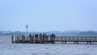 distant view of people on a wooden pier