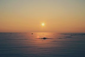 Beautiful panorama of the colorful, gradient sunset over a frozen lake