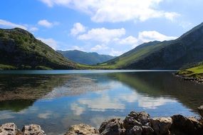 picturesque mountain landscape is reflected in the lake on a sunny day