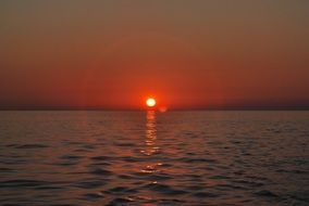 red sun on the horizon of the sea