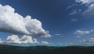 sky in white big clouds over the hills