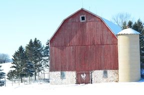 Red Barn at Rural Winter Landscape
