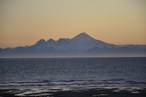 distant Volcano on seashore at dusk, usa, Alaska