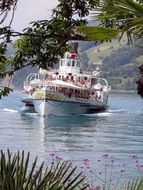 sailing ship with people on lake Thun
