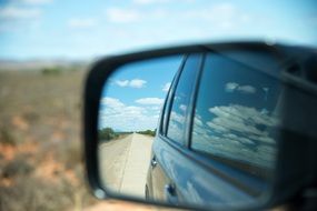panorama of a road in a car mirror in south africa