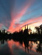 pink sunset at dusk over a lake