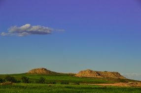 panorama of low mountains among a green meadow
