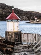 White and red tower Lighthouse on the beautiful coast