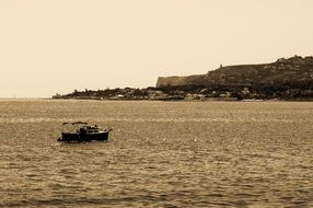 boat in the sea on the background of the coast of Denia