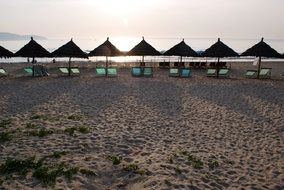 umbrellas with sun loungers on the beach in danang city in vietnam