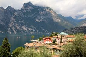 residential buildings on the shores of Lake Garda on a background of mountains in Italy