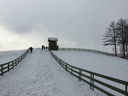 hut on snowy hill in winter