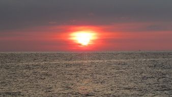 the sun on the red sky on the horizon of the sea