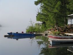 Colorful fishing lodges on the beautiful green shore in Quebec, Canada