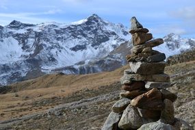 cairn on the background of snowy mountains
