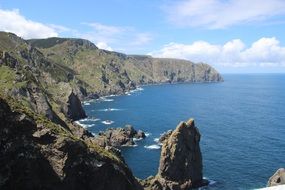 wild dark Cliff at blue ocean, Northern Atlantic, spain