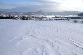 huge snow field in front of mountains