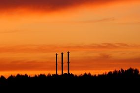 factory chimneys at sunset