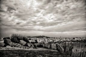 cloudy sky over the landscape in black and white image