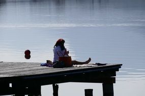 woman on the pier near the lake in kaltern
