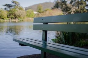 green bench near the lake