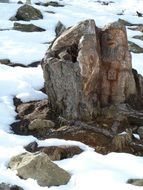 mountain rock in snow drifts