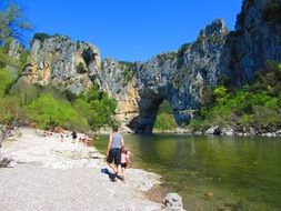 people resting on bank of Ardeche river in colorful scenic Landscape with nature in France
